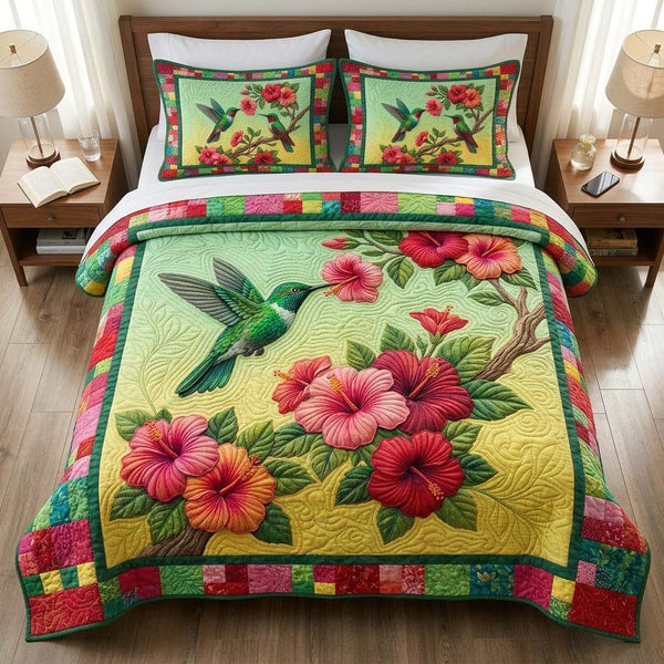 Hummingbird quilted 3-piece bedding set on a made bed with two matching pillow shams