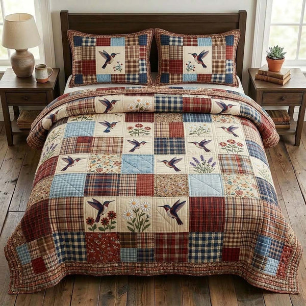 Hummingbird quilted 3-piece bedding set on a made bed with two matching pillow shams