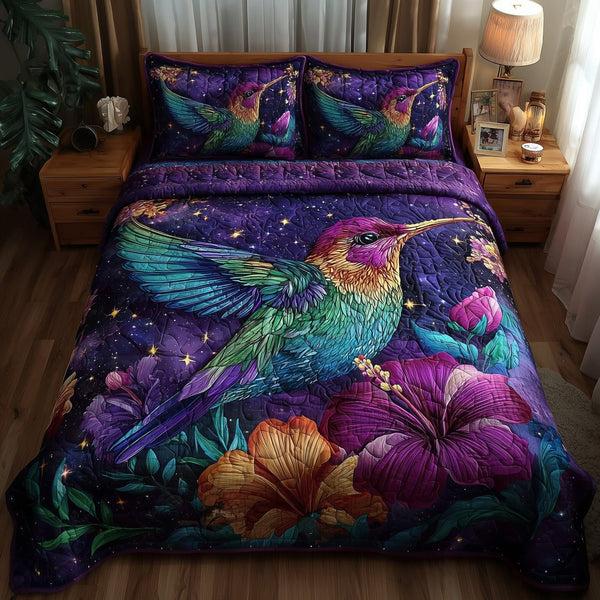 Hummingbird quilted 3-piece bedding set on a made bed with two matching pillow shams