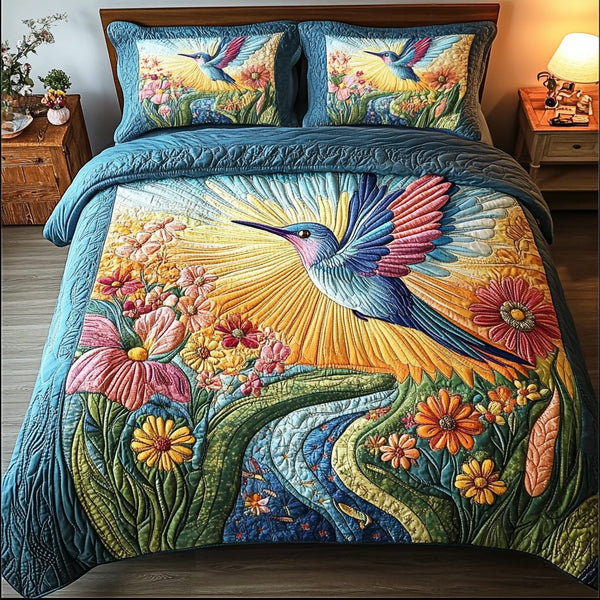 Hummingbird quilted 3-piece bedding set on a made bed with two matching pillow shams