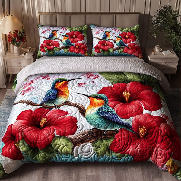 Hummingbird quilted 3-piece bedding set on a made bed with two matching pillow shams