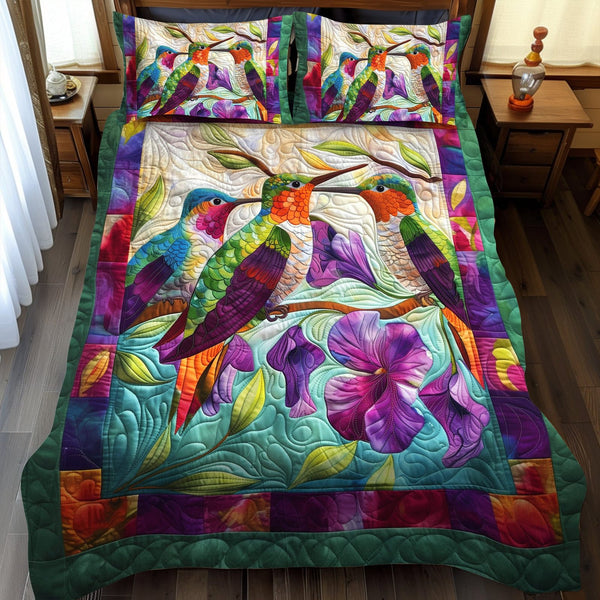 Hummingbird Serenade quilted 3-piece bedding set on a made bed with two matching pillow shams