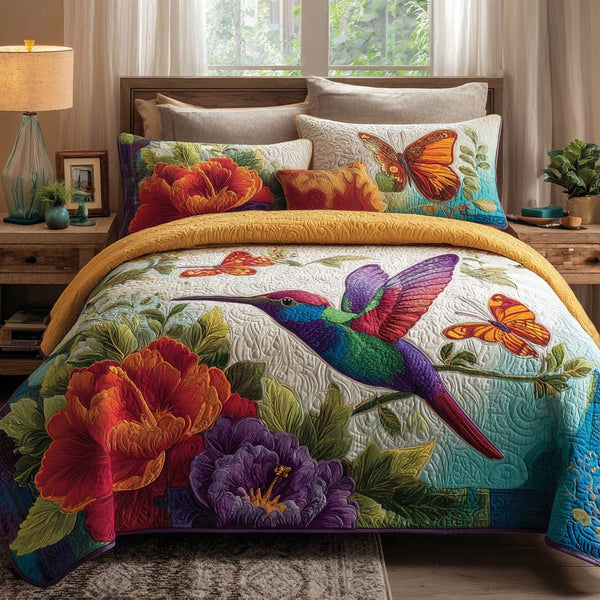 Hummingbird Spirit quilted 3-piece bedding set on a made bed with two matching pillow shams