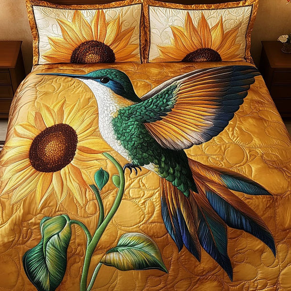 Hummingbird Sunflower quilted 3-piece bedding set on a made bed with two matching pillow shams