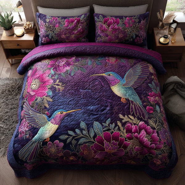 Hummingbird Whisper quilted 3-piece bedding set on a made bed with two matching pillow shams