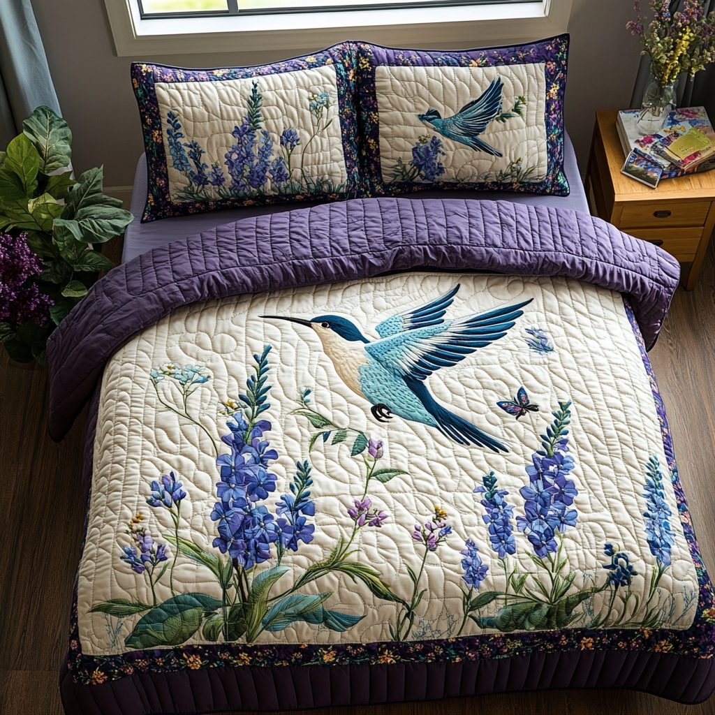 Hummingbird Whispers quilted 3-piece bedding set on a made bed with two matching pillow shams