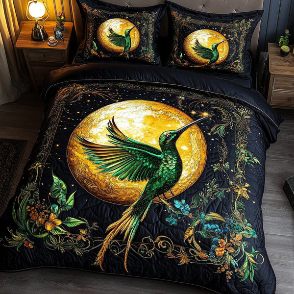Hummingbird Wings quilted 3-piece bedding set on a made bed with two matching pillow shams
