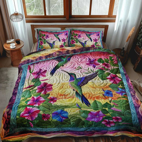 Hummingbird With Sunset quilted 3-piece bedding set on a made bed with two matching pillow shams