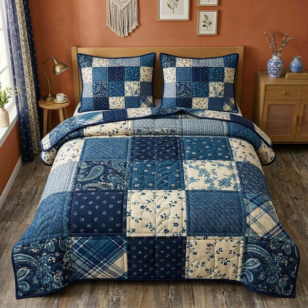 Indigo Patchwork quilted 3-piece bedding set on a made bed in a farmhouse bedroom