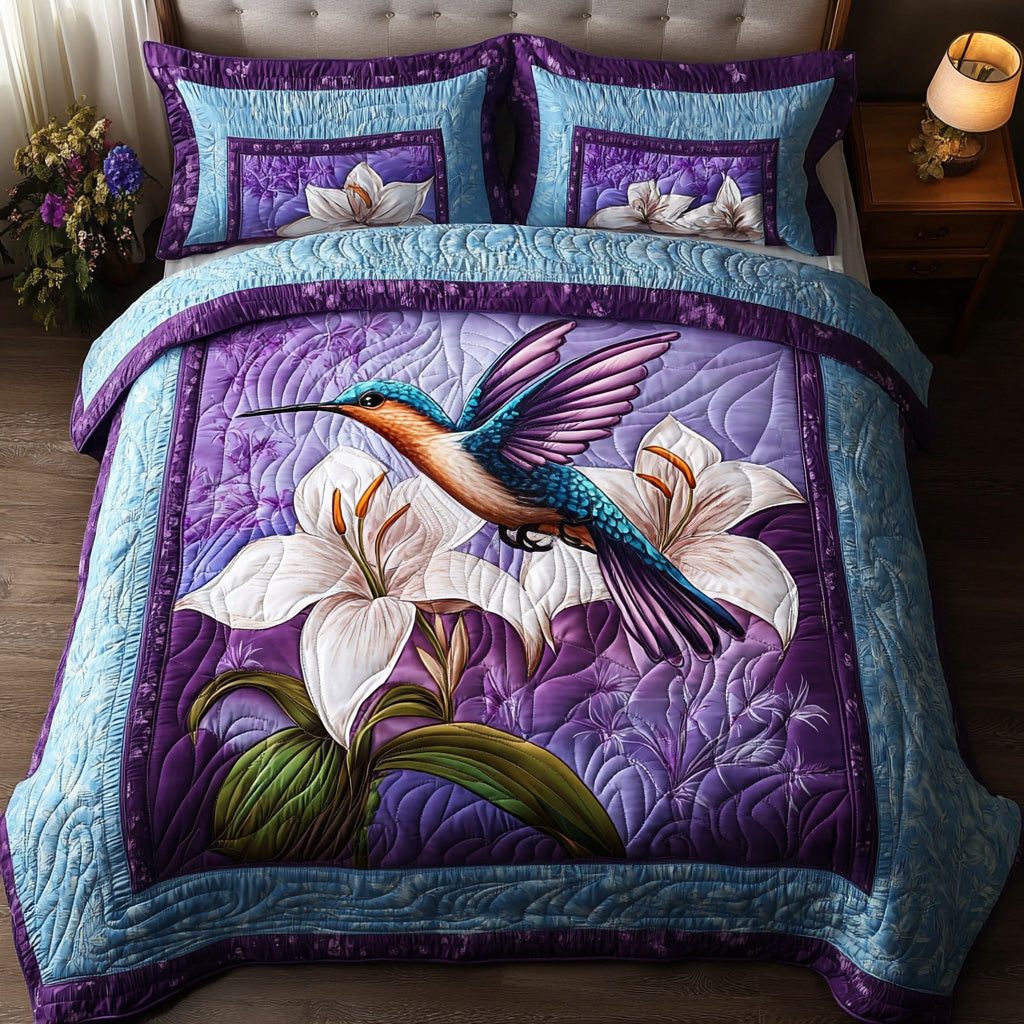 Iridescent Hummingbird quilted 3-piece bedding set on a made bed with two matching pillow shams