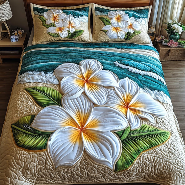 Island Plumera Paradise quilted 3-piece bedding set on a made bed in a light coastal bedroom