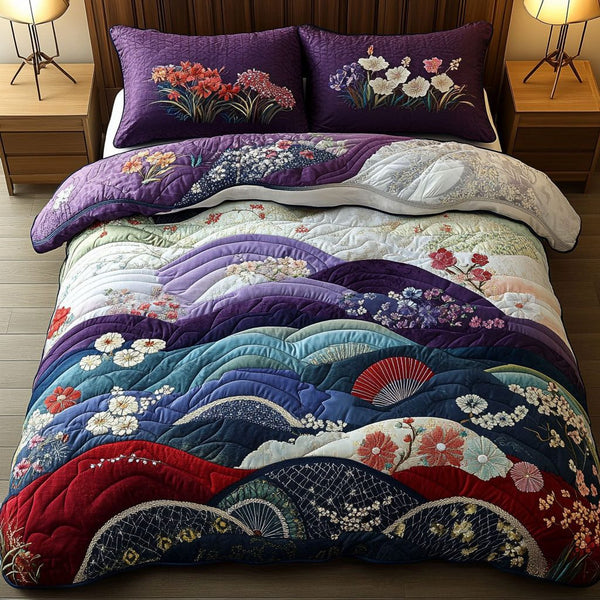Japanese Blossoms quilted 3-piece bedding set on a made bed with two matching pillow shams