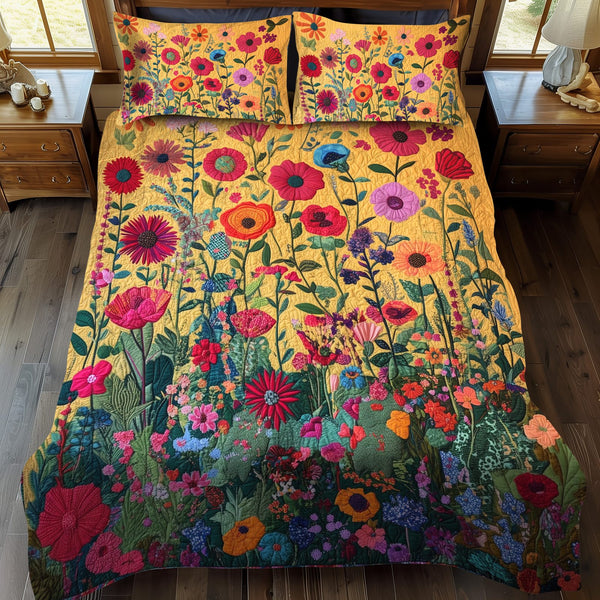 Kaleidoscopic Flowers quilted 3-piece bedding set on a made bed with two matching pillow shams