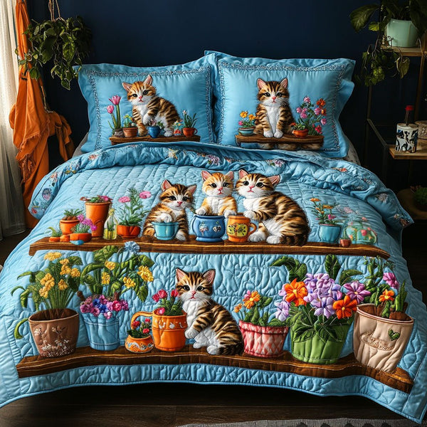 Kitten Garden Party quilted 3-piece bedding set on a made bed with two matching pillow shams