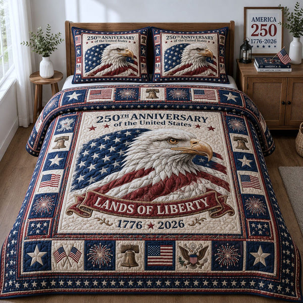 Land Of Liberty quilted 3-piece bedding set on a made bed in a warmly lit bedroom