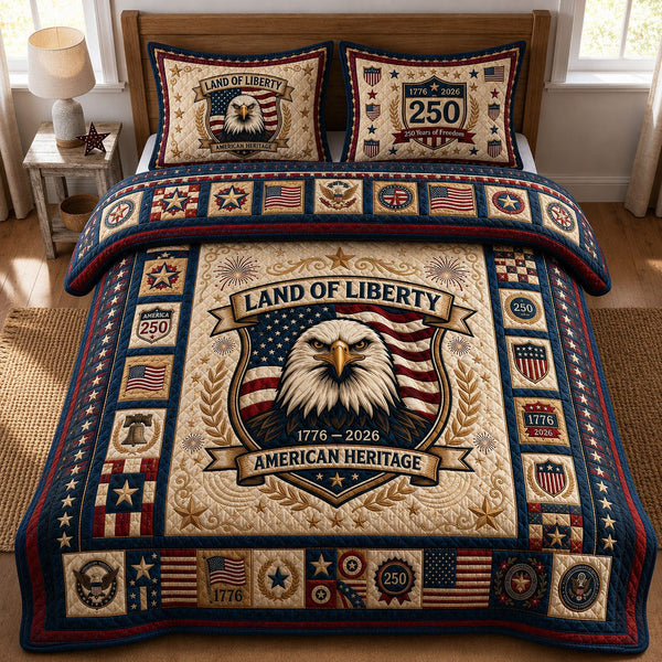 Land Of Liberty quilted 3-piece bedding set on a made bed in a warmly lit bedroom