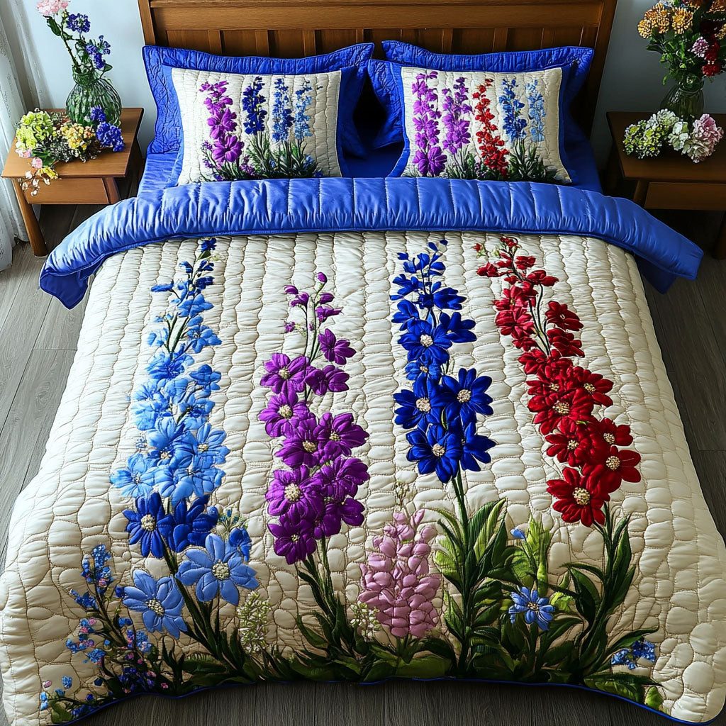 Larkspur Elegance quilted 3-piece bedding set on a made bed with two matching pillow shams
