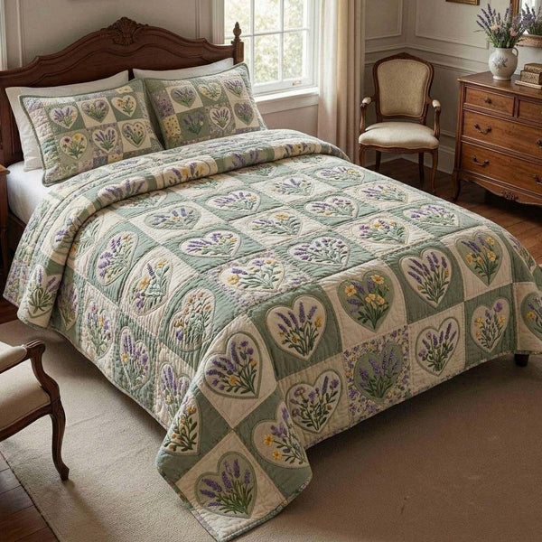 Lavender Garden Hearts quilted 3-piece bedding set on a made bed with two matching pillow shams