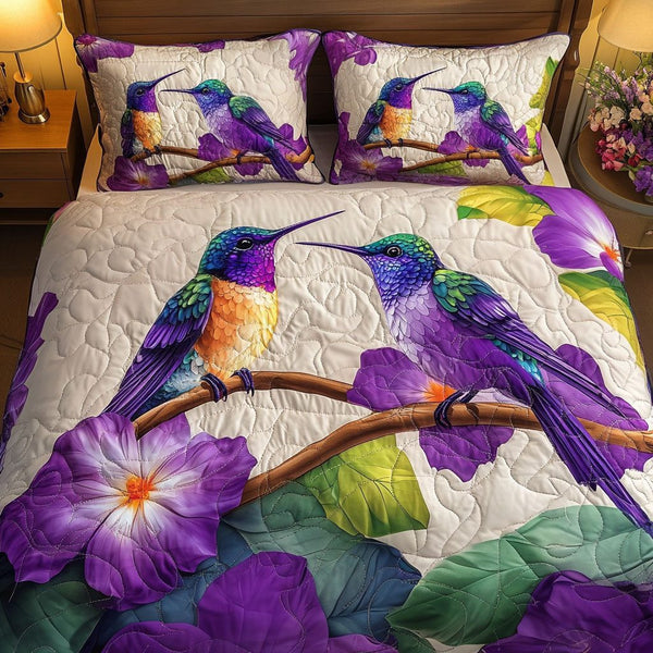 Lavender Glow Dance quilted 3-piece bedding set on a made bed with two matching pillow shams
