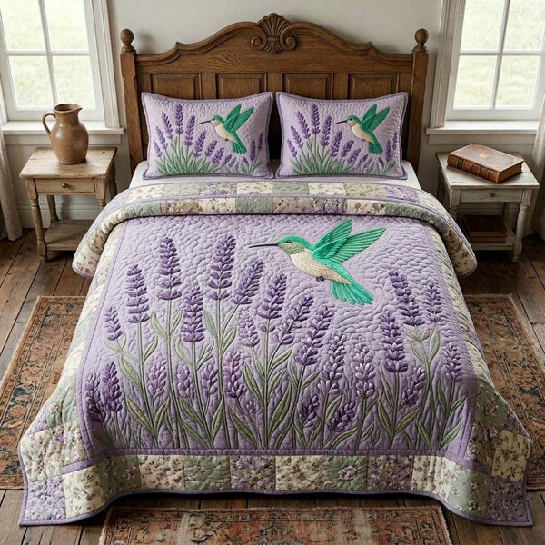 Lavender Humming quilted 3-piece bedding set on a made bed with two matching pillow shams