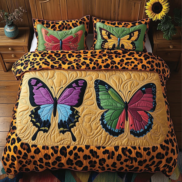 Leopard Butterfly Dream quilted 3-piece bedding set on a made bed with two matching pillow shams