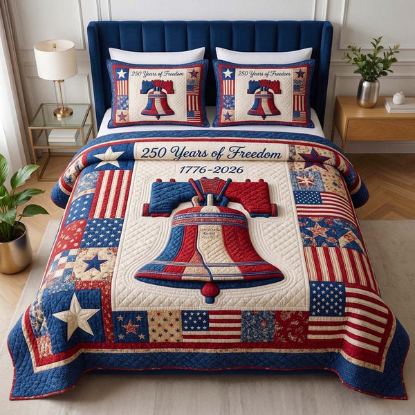 Liberty Bell quilted 3-piece bedding set on a made bed in a warmly lit bedroom