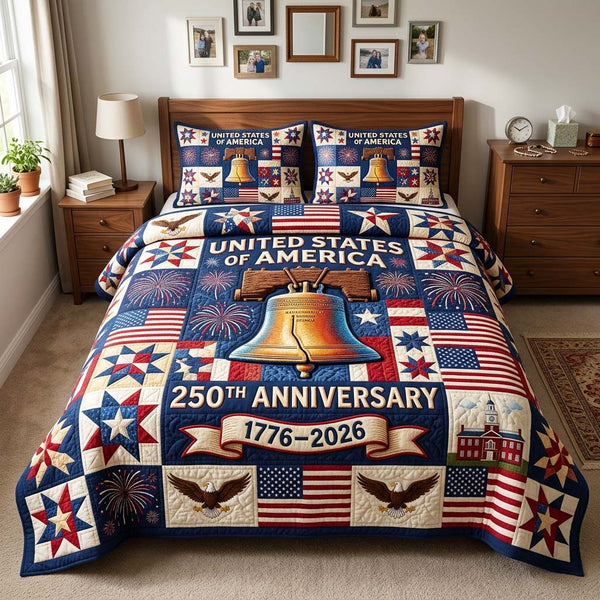 Liberty Bell quilted 3-piece bedding set on a made bed in a warmly lit bedroom