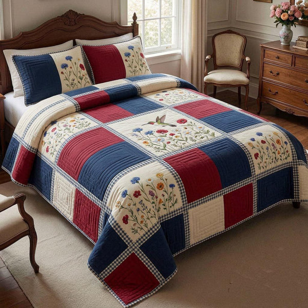 Liberty Bloom quilted 3-piece bedding set on a made bed in a warmly lit bedroom