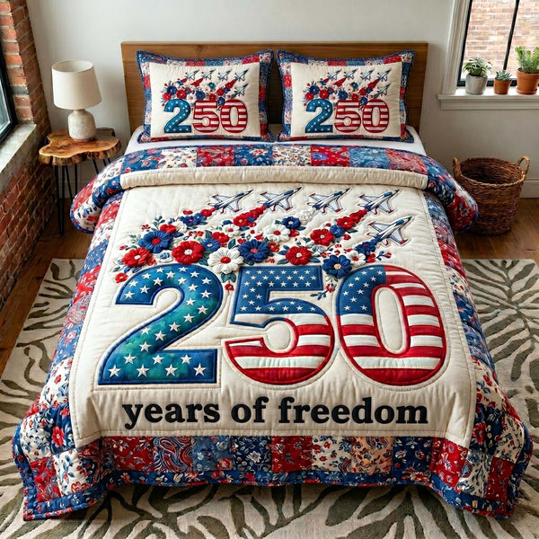 Liberty Legacy quilted 3-piece bedding set on a made bed in a warmly lit bedroom