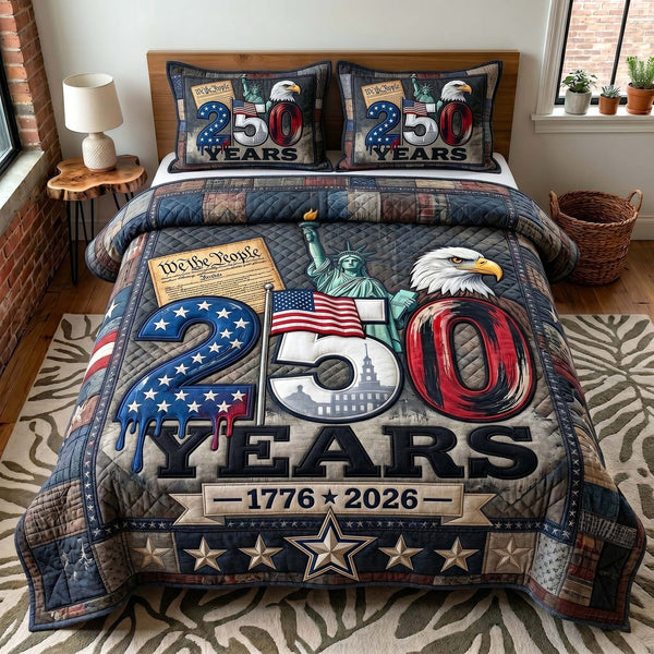 Liberty Legacy quilted 3-piece bedding set on a made bed in a warmly lit bedroom