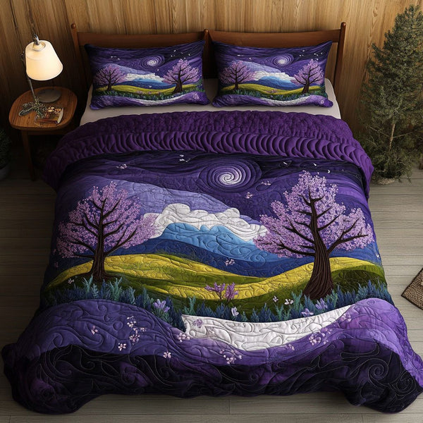Lilac Sunset quilted 3-piece bedding set on a made bed with two matching pillow shams