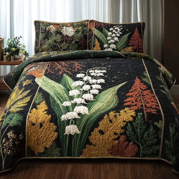 Lily Of The Valley quilted 3-piece bedding set on a made bed with two matching pillow shams