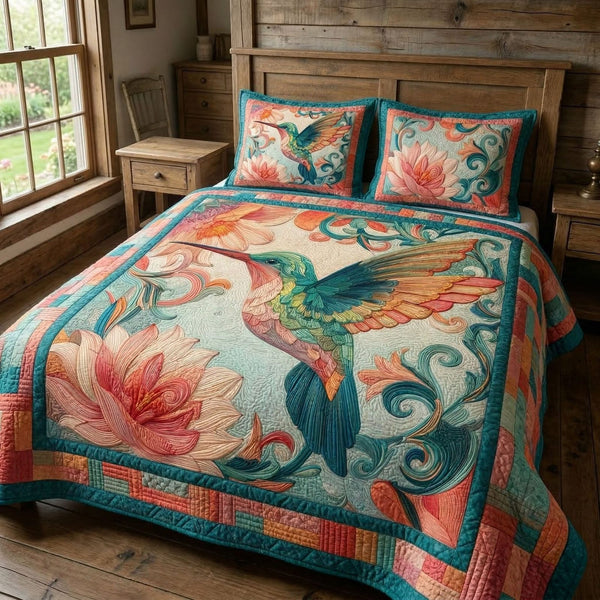 Lotus Hummingbird quilted 3-piece bedding set on a made bed with two matching pillow shams