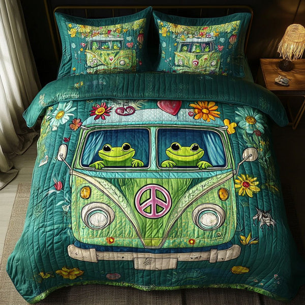 Love Bug Frogs quilted 3-piece bedding set on a made bed with two matching pillow shams