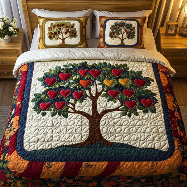 Love Canopy quilted 3-piece bedding set on a made bed with two matching pillow shams