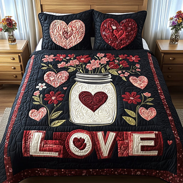 Love Garden quilted 3-piece bedding set on a made bed with two matching pillow shams