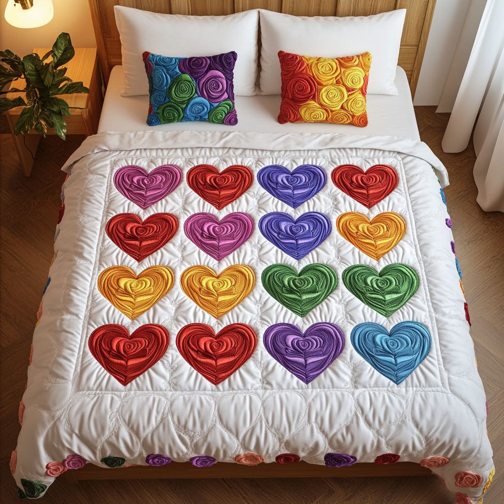 Love Spectrum quilted 3-piece bedding set on a made bed with two matching pillow shams
