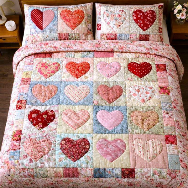 Loving Hearts quilted 3-piece bedding set on a made bed with two matching pillow shams