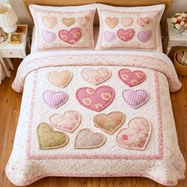 Loving Hearts quilted 3-piece bedding set on a made bed with two matching pillow shams