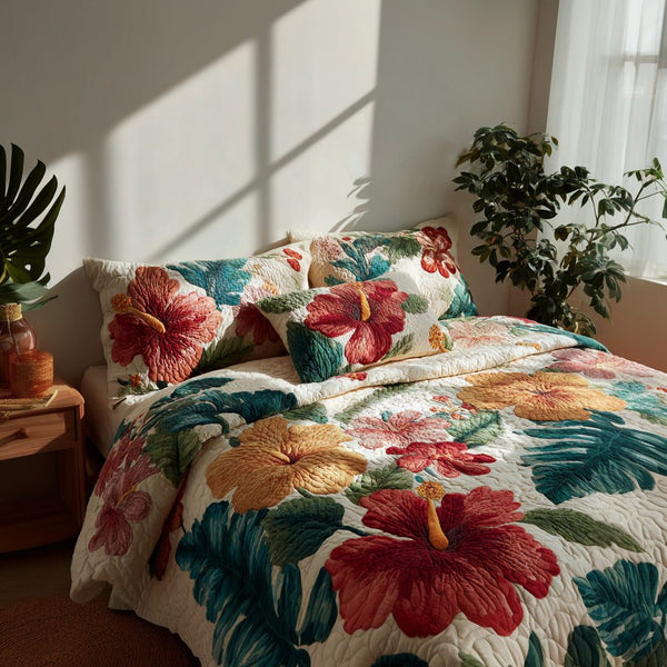 Lush Hibiscus quilted 3-piece bedding set on a made bed with two matching pillow shams