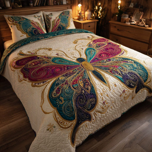 Luxe Monarch quilted 3-piece bedding set on a made bed with two matching pillow shams