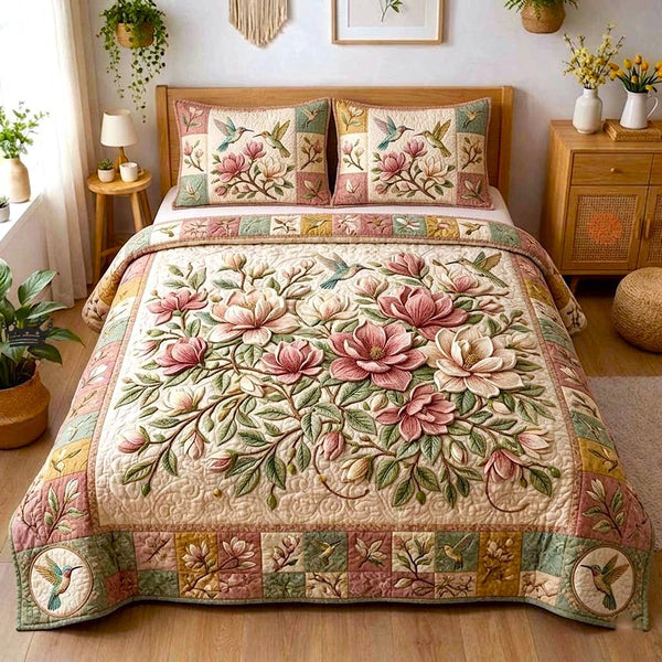 Magnolia Bloom quilted 3-piece bedding set on a made bed with two matching pillow shams