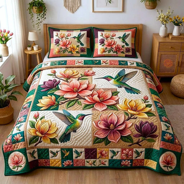 Magnolia Bloom quilted 3-piece bedding set on a made bed with two matching pillow shams
