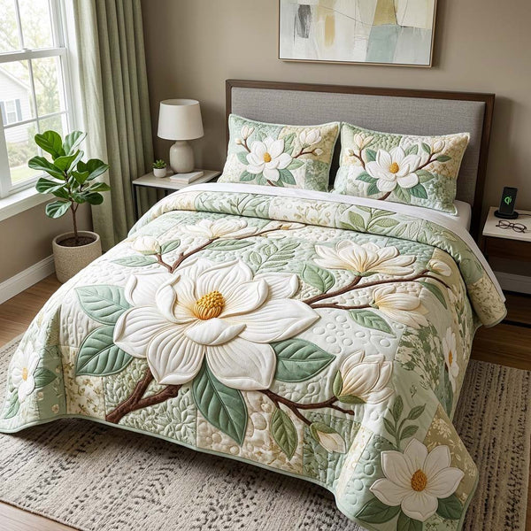 Magnolia Bloom quilted 3-piece bedding set on a made bed with two matching pillow shams