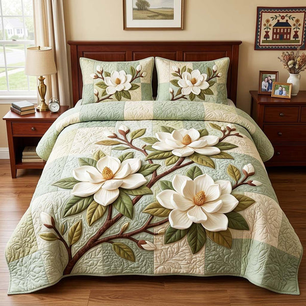 Magnolia Blossom quilted 3-piece bedding set on a made bed with two matching pillow shams