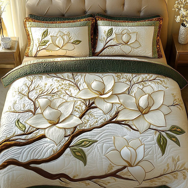 Magnolia Blossom quilted 3-piece bedding set on a made bed with two matching pillow shams