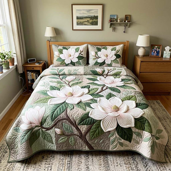 Magnolia Garden quilted 3-piece bedding set on a made bed with two matching pillow shams