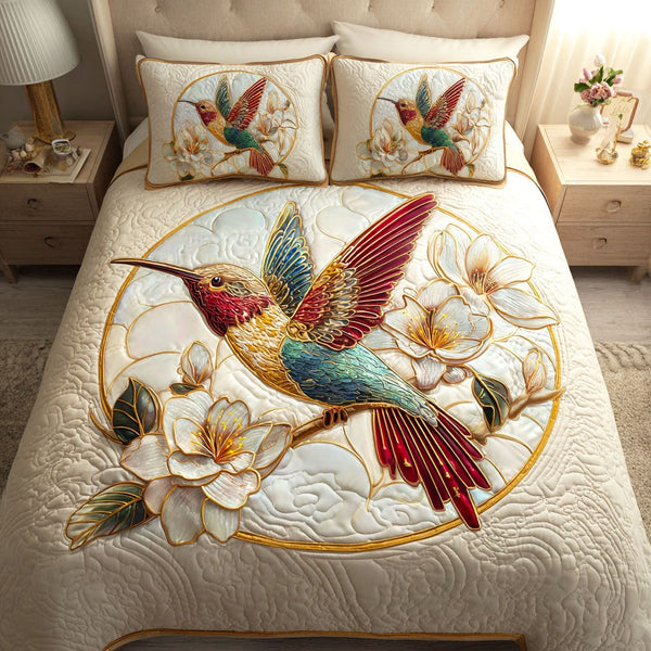 Magnolia Hover quilted 3-piece bedding set on a made bed with two matching pillow shams