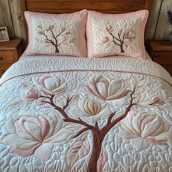 Magnolia Tranquil Charm quilted 3-piece bedding set on a made bed with two matching pillow shams