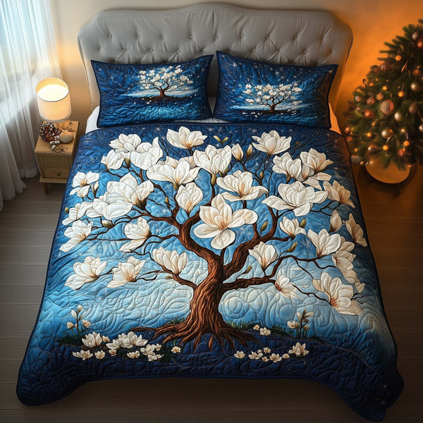 Magnolia Tree quilted 3-piece bedding set on a made bed with two matching pillow shams